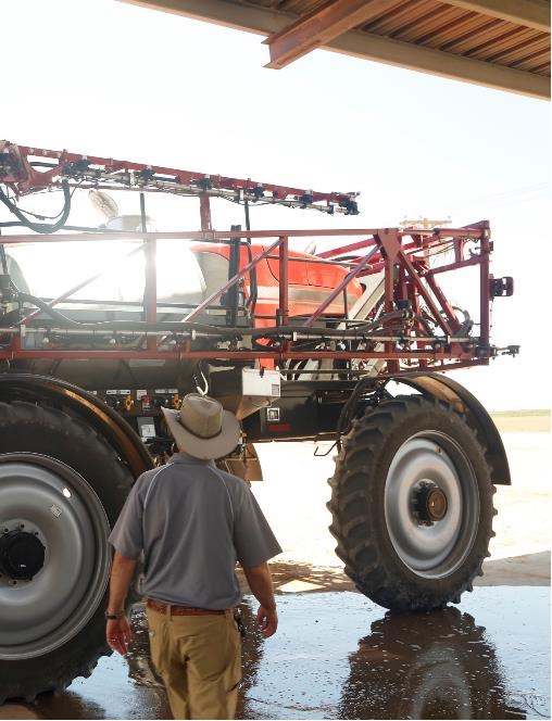 Farmer inspecting a sprayer